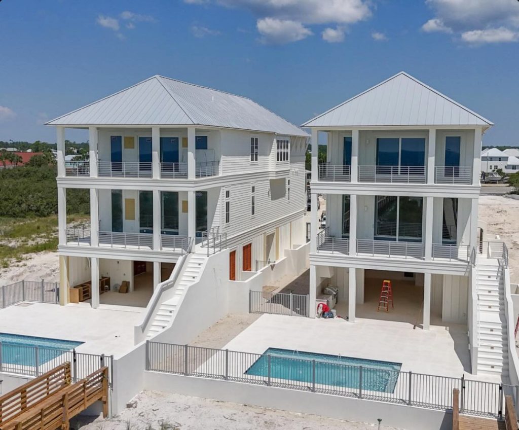 exterior shot of two white houses next to each other