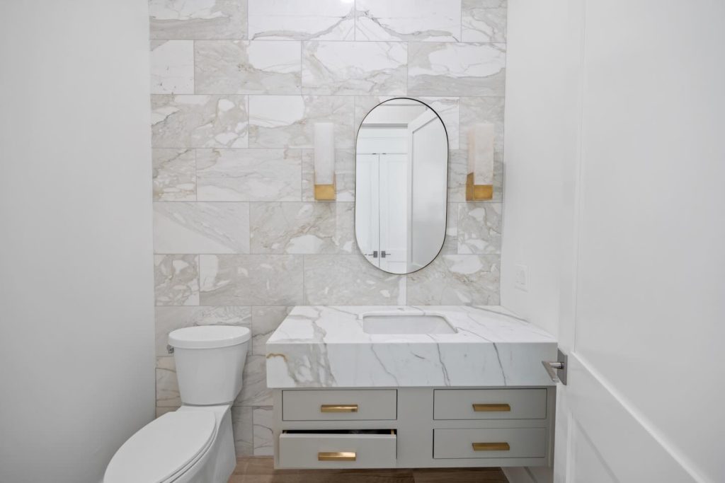 shot of bathroom with toilet and vanity with mirror